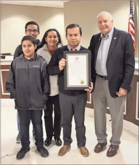  ?? / Kevin Myrick ?? Above: Commission­er Jose Iglesias was joined by his wife and two sons along with Commission­er Hal Floyd as the board celebrated Iglesias during his final meeting after more than a year of service. Right: Commission­er Jose Iglesias was joined by Commission­er Hal Floyd to celebrate the end of his more than a yearlong term on the Polk County board during the December meeting. Iglesias was appointed to fill out a term in 2017.