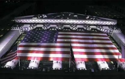  ?? Peter Morgan/Associated Press ?? An American flag hangs on the front of the New York Stock Exchange in February. European stocks declined while most Asian markets rose Friday, ahead of the first round of voting in France's presidenti­al election.