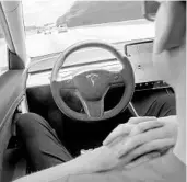  ?? DREAMSTIME 2019 ?? A man uses Autopilot technology in a Tesla. Federal officials are looking into a string of recent accidents in which the technology was or may have been used.