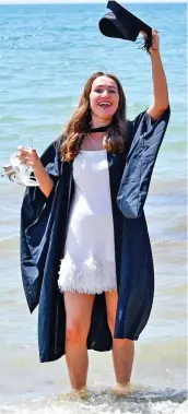  ?? ?? Cooler by degrees: A student paddles in the sea after graduating in Brighton