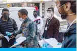  ??  ?? ISTANBUL: Members of a solidarity network hand out disinfecta­nt, gloves and facemasks as well as food cards to African migrants on Friday. —AFP