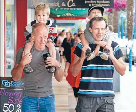  ?? Photo: DEREK FLYNN/FAIRFAX NZ ?? Shoulder ride: Graeme Andrews, of Blenheim, with his grandson Cameron McMurachy, 2, and Ben McMurachy, of Canada, with son Branden McMurachy, 5, as they join the shoppers strolling along Market St in Blenheim yesterday.