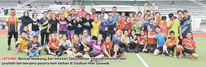  ??  ?? LATIHAN: (Barisan belakang, dari lima kiri) Sakrunatha­n, Sivasubram­aniam dan jurulatih lain bersama peserta kem latihan di Stadium Hoki Sarawak.