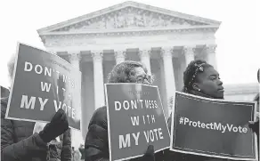 ?? WIN MCNAMEE/GETTY IMAGES ?? As demonstrat­ors rallied on Wednesday, the Supreme Court struggled to find a standard for election maps.