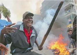  ?? AP ?? Protesting residents of Mathare block the roads with burning tyres. —