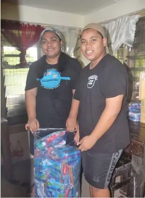  ??  ?? Climate change activist AnnMary Raduva, left, with her sister Faith Raduva packing dignity drive packages at their home in Suva.