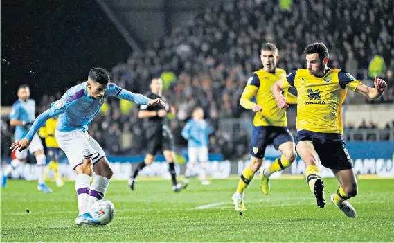  ??  ?? On the mark: Joao Cancelo puts City ahead (above), while Matty Taylor (right) celebrates his equaliser