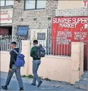  ??  ?? TEMPTATION: Pupils walk past a bar. Joburg tavern owners want to prevent schoolchil­dren from drinking in their uniforms.