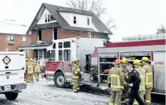 ?? FRANK GUNN/ THE CANADIAN PRESS ?? Firefighte­rs pack up after responding to a house fire in Oshawa, Ont. on Monday. Two adults and two children have been killed in a house fire east of Toronto that also sent three other people to hospital, fire officials said.