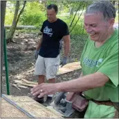  ??  ?? Gary Wall, supervisor of Waterford Township, helps out with carpentry.