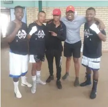  ?? Picture: SUPPLIED ?? ALL IN HAND: Khwezi Booi with boxers who fought in his tournament in Queenstown, together with junior-flyweight sensation Sive Nontshinga.