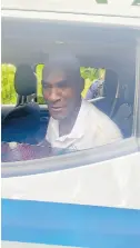  ?? PHOTO BY JANET SILVERA ?? Paul Adams, principal of Herbert Morrison Technical High, speaks to the media while sitting in a police service vehicle, moments after he was found on Monday afternoon.