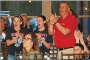  ?? PAUL DICICCO — THE NEWS-HERALD ?? Mentor girls track and field coach Bob Berwald cheers as Mitchell Trubisky is selected by the Bears in the NFL draft on April 27.