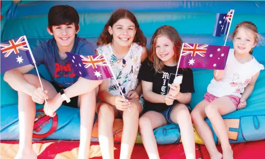  ?? Photograph: MICHAEL ROBINSON ?? Flying their flags for Australia Day celebratio­ns at Drouin on Wednesday morning are the Perry siblings (from left) Phinn, Lorelei, Edolie and Reygan. More photograph­s: pages 23-25