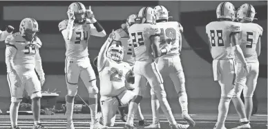  ?? ROB SCHUMACHER/THE REPUBLIC ?? Thunderbir­d Titans fullback Greg Smith (21) reacts after scoring the game winning touchdown against the Marcos de Niza Padres during a 4A playoff game at Marcos de Niza High.