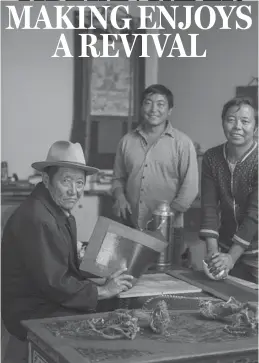  ??  ?? Tsering Tobgyal and his two sons display a special Tibetan scripture paper, which was ordered by Tashilhunp­o Monastery at their workshop in Nyemo county, Tibet autonomous region.