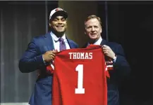  ??  ?? Stanford's Solomon Thomas, left, poses with NFL commission­er Roger Goodell after being selected by the San Francisco 49ers with the No. 3 pick in the first round of the 2017 NFL Draft.