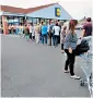  ??  ?? People queue at Grimsby’s Lidl for their cut-price prosecco
