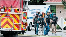  ?? MATT BUTTON/BALTIMORE SUN ?? A group of ATF police makes its way to the shooting scene in northeaste­rn Maryland.