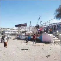  ??  ?? People gather at the scene of a blast which struck a military graduation parade in the town of Al-Dhalea, Yemen, yesterday.