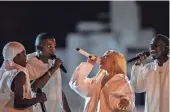  ?? ANDY ABEYTA/THE DESERT SUN ?? Doja Cat performs with South African acapella group The Joy during her headlining set on the Coachella Stage during the Coachella Valley Music and Arts Festival in Indio on Sunday.