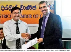  ??  ?? Hambantota District Chamber of Commerce President D.W. Anura Upul and USAID Youlead Project Director Charles Conconi share signed Mous