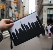  ?? SUBMITTED ?? An Anne Cate wristlet clutch featuring the New York City skyline is featured within the city itself.