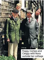  ??  ?? Foggy, Compo and Cleggy with Nora outside her cottage