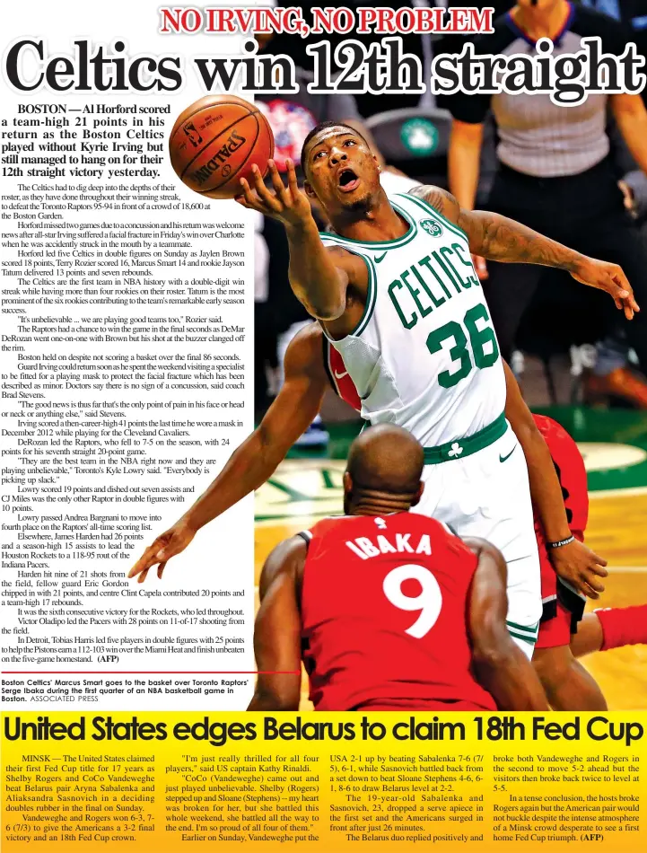  ?? ASSOCIATED PRESS ?? Boston Celtics' Marcus Smart goes to the basket over Toronto Raptors' Serge Ibaka during the first quarter of an NBA basketball game in Boston.