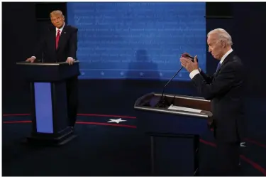  ?? AP PHOTO/ MORRY GASH, POOL ?? Democratic presidenti­al candidate former Vice President Joe Biden answers a question as President Donald Trump listens during the second and final presidenti­al debate Oct. 22, 2020, at Belmont University in Nashville, Tenn.