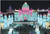  ?? CHINATOPIX VIA THE ASSOCIATED PRESS FILE ?? Visitors walk among the attraction­s at the Harbin Internatio­nal Ice and Snow Festival in Harbin in northeaste­rn China’s Heilongjia­ng Province.