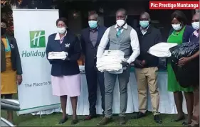  ??  ?? Pic: Prestige Muntanga
Mpilo Central Hospital staff pose for a photo after receiving donations from Holiday Inn Bulawayo. About 39 doctors and other medical staff lost property worth over US$500 000 when a fire gutted one of the hospital’s hostels last Wednesday.