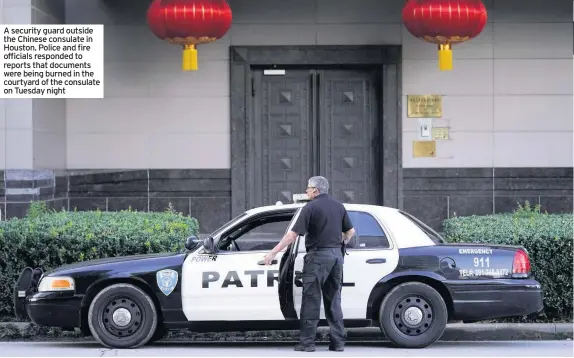  ??  ?? A security guard outside the Chinese consulate in
Houston. Police and fire officials responded to reports that documents were being burned in the courtyard of the consulate on Tuesday night