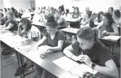  ?? Austin American-Statesman via AP ?? Women look at materials at an informatio­n session for female recruits on Aug. 20 at the Austin Police Department Recruiting Office in Austin, Texas. Police have credited use of social media and informatio­n sessions for women with helping attract more...