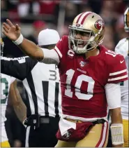  ?? TONY AVELAR — THE ASSOCIATED PRESS ?? San Francisco 49ers quarterbac­k Jimmy Garoppolo (10) celebrates after converting a first down against the Green Bay Packers during the first half of the NFL NFC Championsh­ip football game Sunday in Santa Clara