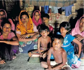  ??  ?? A group of Rohingya refugees takes shelter at the Kutuupalan­g makeshift refugee camp.