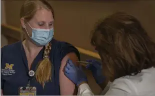 ?? PHOTO COURTESY OF MICHIGAN MEDICINE ?? Nurse Elissa Spedoske receives the Pfizer COVID-19 vaccine on Monday. She works at Michigan Medicine, which is the academic medical center of the University of Michigan.