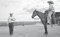  ?? Los Angeles Times/TNS ?? Rancher Cliven Bundy, left, and his son, Arden, stand on land the family has worked since the 1880s on Aug. 20, 2013, in Bunkervill­e, Nev. A federal judge has declared a mistrial in the case involving Bundy and his two sons after she found prosecutor­s...