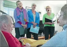  ?? RODRIQUE NGOWI/AP PHOTO ?? Members of Journey Songs sing on May 2 for Norman and Jean Doelling at their Newton, Mass., home. One of a growing number of hospice choirs across the country, the all-volunteer group sings, by invitation only, at the bedsides of the elderly and...