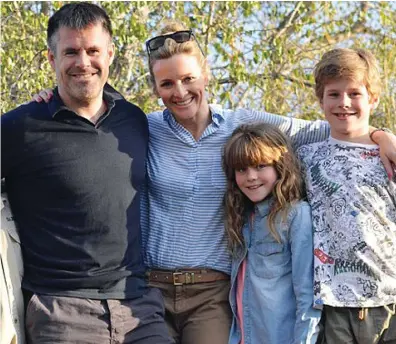  ??  ?? Happy family: TV presenter Gabby Logan with husband Kenny and twins Lois and Reuben