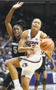  ?? John Woike / TNS ?? UConn’s Napheesa Collier battles for a rebound with UCF’s Masseny Kaba (5) during the first half on Tuesday night at Gampel Pavilion in Storrs.