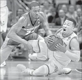  ?? Keith Srakocic Associated Press ?? VILLANOVA’S Jalen Brunson grabs for a loose ball in front of Radford's Ed Polite Jr. during the second half. Brunson scored 16 points in the Wildcats’ 87-61 victory.