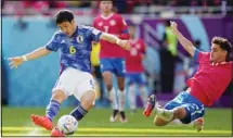  ?? ?? Costa Rica’s Yeltsin Tejeda (right), tries to block a shot from Japan’s Wataru Endo during the World Cup, group E soccer match between Japan and Costa Rica, at the Ahmad Bin Ali Stadium in Al Rayyan, Qatar. (AP)