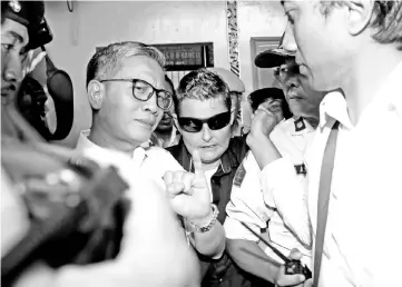  ?? — Reuters photo ?? Lawrence (centre) is released from prison in Bangli Regency, Bali, Indonesia.