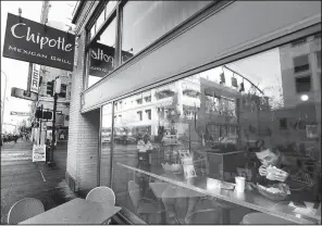  ?? AP/DON RYAN ?? A customer eats lunch at a Chipotle restaurant in Portland, Ore., in 2015.