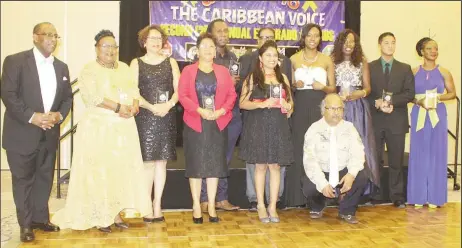  ??  ?? Some of the awardees with founder of the Caribbean Voice Anand Boodram (stooping in front).