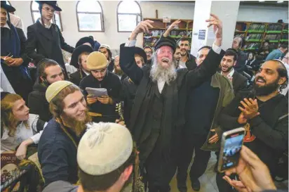  ?? (Vladyslav Musiienko/Reuters) ?? ULTRA-ORTHODOX Jewish pilgrims celebrate Rosh Hashanah at the tomb of Rabbi Nachman of Breslov amid Russia’s attack on Ukraine, in Uman, this week.