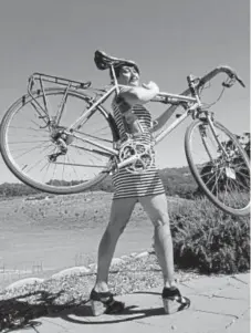  ??  ?? Tessa Hulls with her bike, which she rode from Seattle to a wedding outside of Los Angeles.