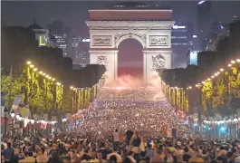  ??  ?? People celebrate France's victory in front of The Arc de Triomphe on the Champs Elysees in Paris.