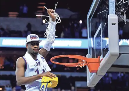  ?? KYLE TERADA/USA TODAY SPORTS ?? Kansas guard Malik Newman was the main reason the Jayhawks cut down the net Sunday after the Midwest Region final as he scored 32 points and sealed the overtime victory from the free throw line.